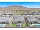 An aerial view shows the lush backyard and mountain views in this desert community at 3466 E Hazeltine Way, Queen Creek, AZ 85142