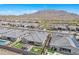 Aerial view of homes in a desert community featuring well-kept yards and views of the surrounding mountains at 3466 E Hazeltine Way, Queen Creek, AZ 85142