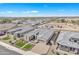 An aerial shot of this home shows the large garage and the lush front yard and desert landscaping at 3466 E Hazeltine Way, Queen Creek, AZ 85142