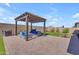 Backyard space with a pergola, comfortable seating, and low-maintenance landscaping at 3466 E Hazeltine Way, Queen Creek, AZ 85142