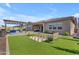 Spacious backyard with green artificial turf, outdoor seating, and pergola for entertaining at 3466 E Hazeltine Way, Queen Creek, AZ 85142