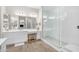 Bright bathroom with a double sink vanity, a large mirror, a walk-in shower with glass doors, and wood look floors at 3466 E Hazeltine Way, Queen Creek, AZ 85142