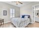 Cozy bedroom featuring white plantation shutters, wood look floors, and stylish neutral decor at 3466 E Hazeltine Way, Queen Creek, AZ 85142