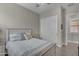 Comfortable bedroom showcasing a neutral color palette, plantation shutters, and wood-look tile flooring at 3466 E Hazeltine Way, Queen Creek, AZ 85142