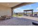 Covered patio with outdoor dining set and ample space for relaxing and entertaining at 3466 E Hazeltine Way, Queen Creek, AZ 85142