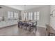 Bright dining room with plantation shutters, wood floors, and charming farmhouse table setting at 3466 E Hazeltine Way, Queen Creek, AZ 85142
