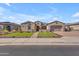 Attractive home featuring a well-manicured lawn and landscaping with a paved driveway at 3466 E Hazeltine Way, Queen Creek, AZ 85142