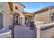 Inviting front porch with decorative tile, seating area, and an arched doorway leading to the entrance at 3466 E Hazeltine Way, Queen Creek, AZ 85142