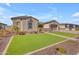 Charming single-story home with manicured front yard featuring artificial turf and desert landscaping at 3466 E Hazeltine Way, Queen Creek, AZ 85142
