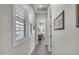 Hallway filled with natural light from plantation shutters and doors leading to other rooms at 3466 E Hazeltine Way, Queen Creek, AZ 85142