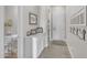 Bright hallway featuring white wainscoting, decor and access to the powder room at 3466 E Hazeltine Way, Queen Creek, AZ 85142