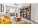 Inviting living room featuring bookshelves, comfortable seating, and natural light at 3466 E Hazeltine Way, Queen Creek, AZ 85142