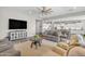 Spacious living room with an open floor plan, modern furnishings, and a large television at 3466 E Hazeltine Way, Queen Creek, AZ 85142