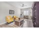 Cozy living room with yellow armchairs, stylish décor, and neutral walls at 3466 E Hazeltine Way, Queen Creek, AZ 85142