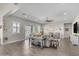 Bright living room with a ceiling fan, sliding glass doors, and a view of the backyard at 3466 E Hazeltine Way, Queen Creek, AZ 85142