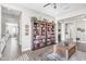 Bright living room with hardwood floors, a ceiling fan, and custom built-in bookshelves at 3466 E Hazeltine Way, Queen Creek, AZ 85142
