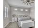 Relaxing main bedroom with a ceiling fan, decorative pillows, white bedroom furniture, and wood look floors at 3466 E Hazeltine Way, Queen Creek, AZ 85142