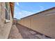 Pebbled side yard with block wall providing privacy and low-maintenance landscaping at 3466 E Hazeltine Way, Queen Creek, AZ 85142