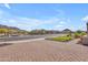 Neighborhood street view featuring well-maintained homes, desert landscaping, and mountain views under a blue sky at 3466 E Hazeltine Way, Queen Creek, AZ 85142