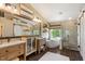 Bright bathroom featuring double vanities, a soaking tub, and a separate tiled shower with a glass door at 4046 E Laurel Ave, Gilbert, AZ 85234