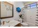 Charming bathroom features a single vanity, tub-shower combo, and stylish shiplap walls for a serene experience at 4046 E Laurel Ave, Gilbert, AZ 85234