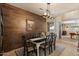 Inviting dining room features a stylish wood accent wall and a modern chandelier above the dining table at 4046 E Laurel Ave, Gilbert, AZ 85234