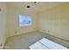 Empty bedroom with concrete floor and natural light through the window, ready for personalization at 4160 N Tamarax Dr, Eloy, AZ 85131