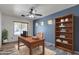 Inviting office with a wood desk, chair, and ample shelving, offering a perfect work-from-home environment at 4968 E Westchester Dr, Chandler, AZ 85249