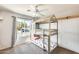 Charming bedroom featuring a wooden bunk bed, ceiling fan, and a view to the outdoors through a bright window at 11822 W Softwind Dr, Sun City, AZ 85373