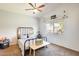 Cozy bedroom with vaulted ceiling, a ceiling fan, large window, carpeted floor and minimalist decor at 11822 W Softwind Dr, Sun City, AZ 85373