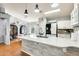 Modern kitchen featuring a spacious island with granite countertop and stainless steel appliances, flowing into the dining area at 11822 W Softwind Dr, Sun City, AZ 85373