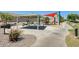Community playground area featuring covered picnic tables and play structures with slides and other recreational equipment at 11822 W Softwind Dr, Sun City, AZ 85373