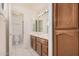 A full bathroom features double vanity, wood cabinets and full shower stall at 15460 W Amelia Dr, Goodyear, AZ 85395