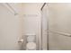 Bright bathroom features white toilet and a glass enclosed shower stall at 15460 W Amelia Dr, Goodyear, AZ 85395
