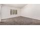 This bedroom features light gray carpet, white walls and shutters on the window at 15460 W Amelia Dr, Goodyear, AZ 85395