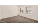 Bright bedroom featuring neutral paint, carpet, and shuttered windows overlooking the neighborhood at 15460 W Amelia Dr, Goodyear, AZ 85395