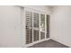 Sliding glass doors with white shutters bring the outdoors in the room at 15460 W Amelia Dr, Goodyear, AZ 85395