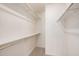 A walk-in closet features shelves, clothes hanging racks and neutral carpeting at 15460 W Amelia Dr, Goodyear, AZ 85395