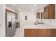 Bright kitchen features stainless steel appliances, tile floor and white countertops at 15460 W Amelia Dr, Goodyear, AZ 85395
