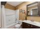 Bathroom with shower over tub, dark vanity, and decorated mirror at 16642 N 35Th Way, Phoenix, AZ 85032