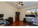 Office setup in a bedroom with dual monitor setup, ceiling fan, and natural light at 16642 N 35Th Way, Phoenix, AZ 85032