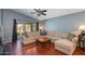 Spacious living room with a comfortable sectional sofa and sliding glass doors to the backyard at 16642 N 35Th Way, Phoenix, AZ 85032