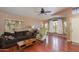 Cozy living room with hardwood floors, a ceiling fan, and large windows with natural light at 16642 N 35Th Way, Phoenix, AZ 85032