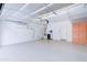 Clean garage with epoxy flooring, storage racks, AC unit, and built-in cabinets at 2813 E Crescent Way, Gilbert, AZ 85298