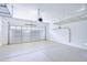 Spacious garage with epoxy floor, storage racks, and insulated garage door at 2813 E Crescent Way, Gilbert, AZ 85298