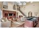 Inviting living room with a soaring ceiling, built-in entertainment center, and elegant staircase at 3054 W Eagle Claw Dr, Phoenix, AZ 85086