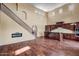 An open living space with a high ceiling, a fireplace, and a kitchen featuring dark wood cabinetry at 3054 W Eagle Claw Dr, Phoenix, AZ 85086
