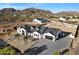 Aerial view of a luxurious home featuring desert landscaping, mountain views, and ample parking space at 3323 N 81St St, Mesa, AZ 85207