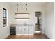 Bright bar area with modern shelving, stylish lighting, wine refrigerator, and direct access to a bathroom at 3323 N 81St St, Mesa, AZ 85207