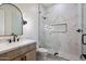 Modern bathroom featuring a glass shower door, marble tiling, and updated fixtures at 3323 N 81St St, Mesa, AZ 85207